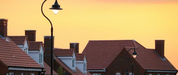 sunset over houses, stock photo by Tom Thain