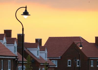 sunset over houses, stock photo by Tom Thain