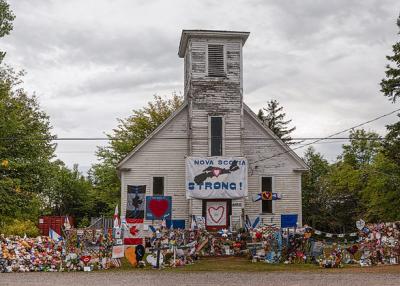 A spontaneous memorial. A church is covered with teddy bears and flowers and a banner reading "Nova Scotia Strong" 